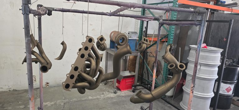 Exhaust components suspended from a workshop rack