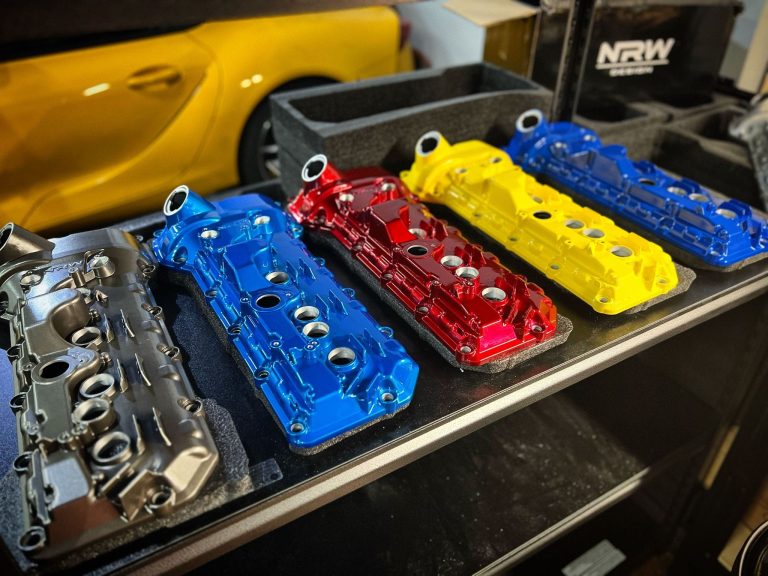 Row of engine covers displayed on a workshop counter
