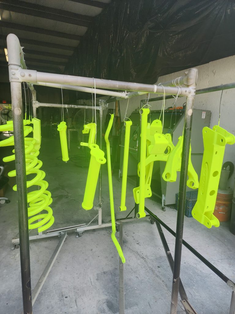 Vehicle parts suspended from a workshop rack