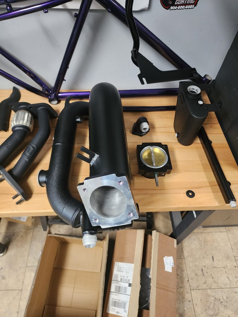 Exhaust pipes and related components arranged on a workbench