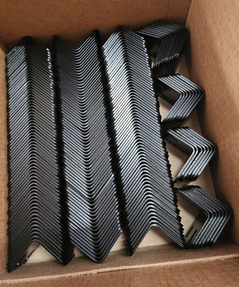 Matching angled brackets stacked inside a box