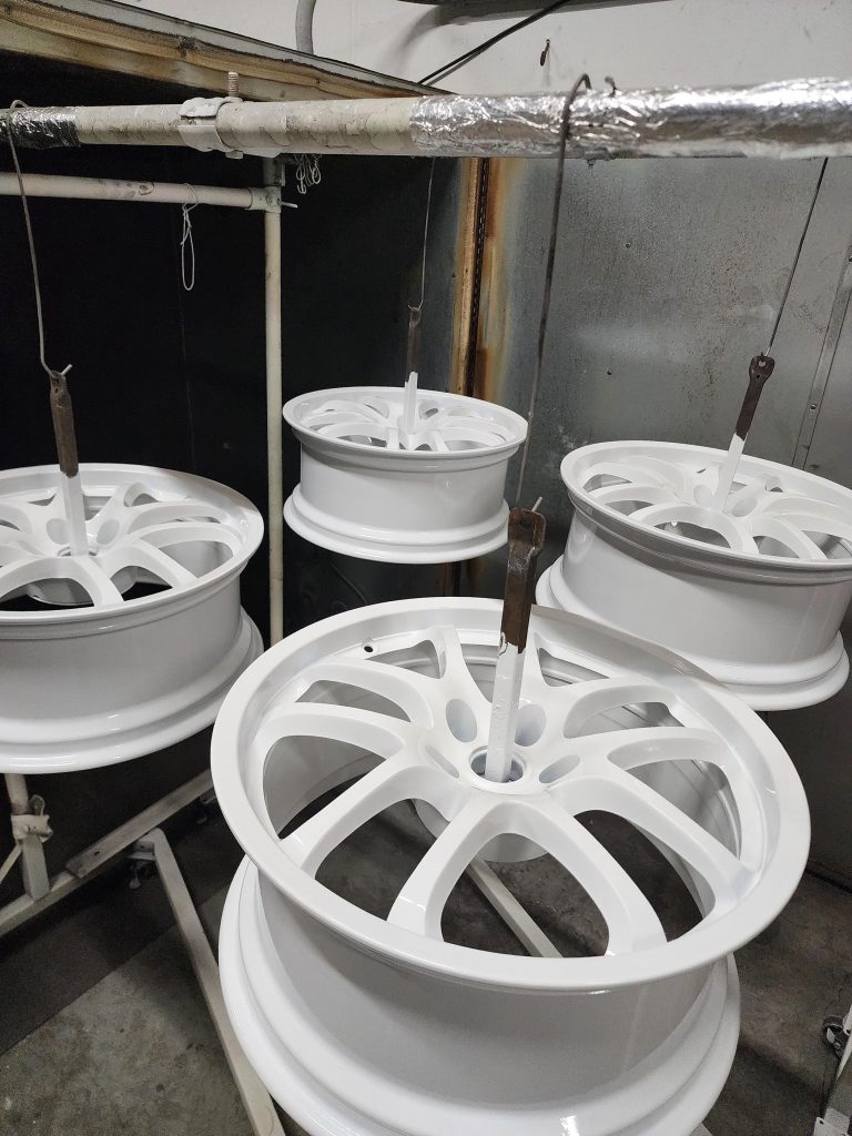 Set of multi-spoke wheels suspended in the workshop
