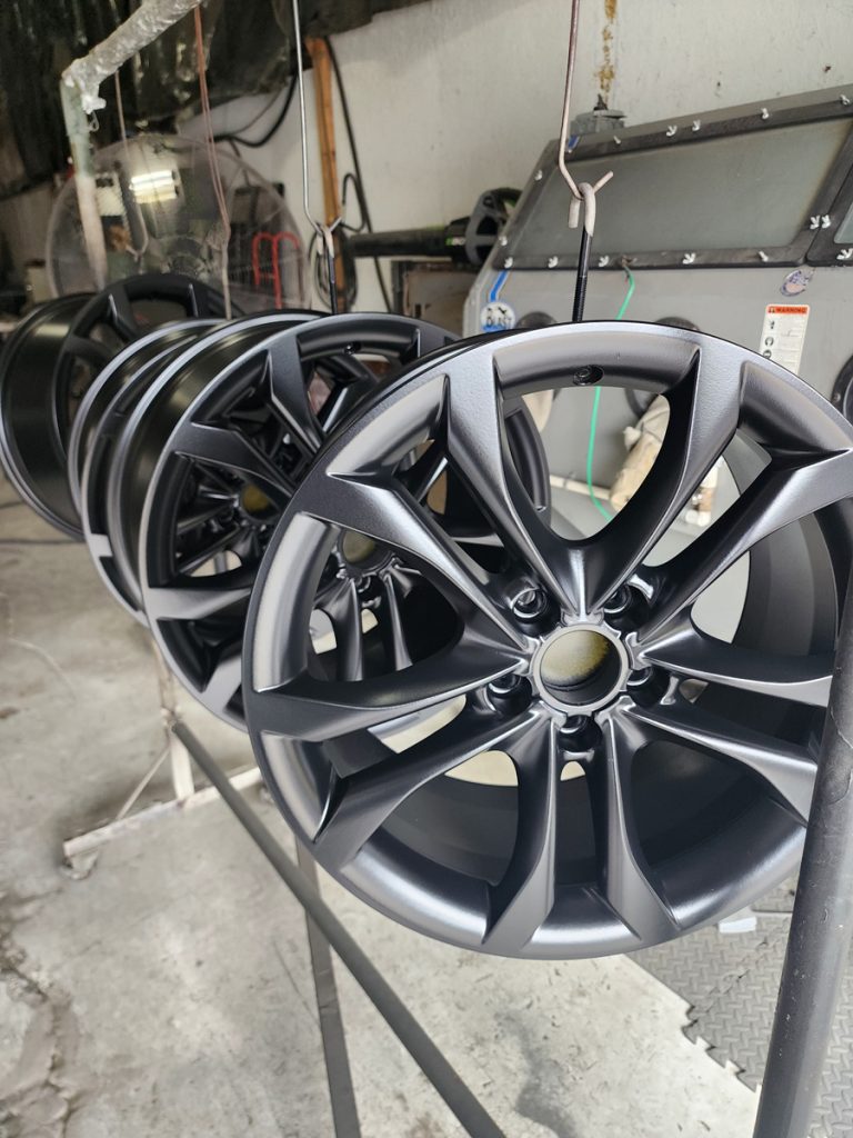 Split-spoke wheel displayed on a workshop stand