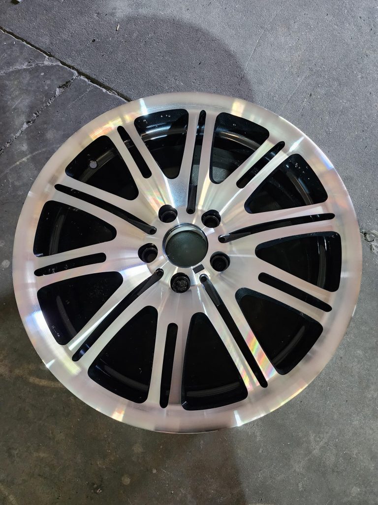 Wheel with paired spokes resting on the workshop floor