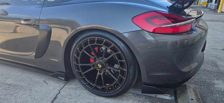 Rear wheel fitted to a coupe outside the workshop