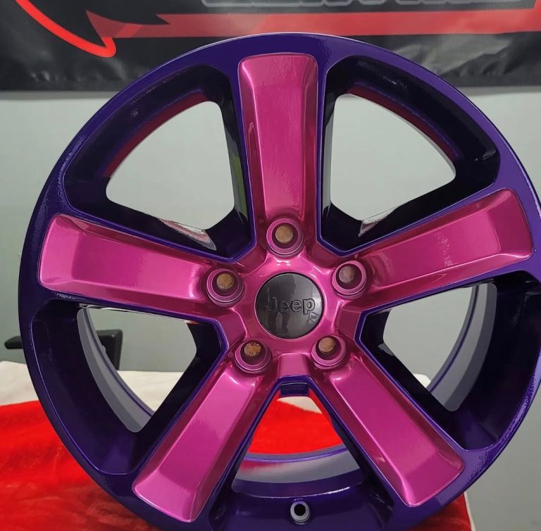 Five-spoke wheel displayed in front of the Raven banner